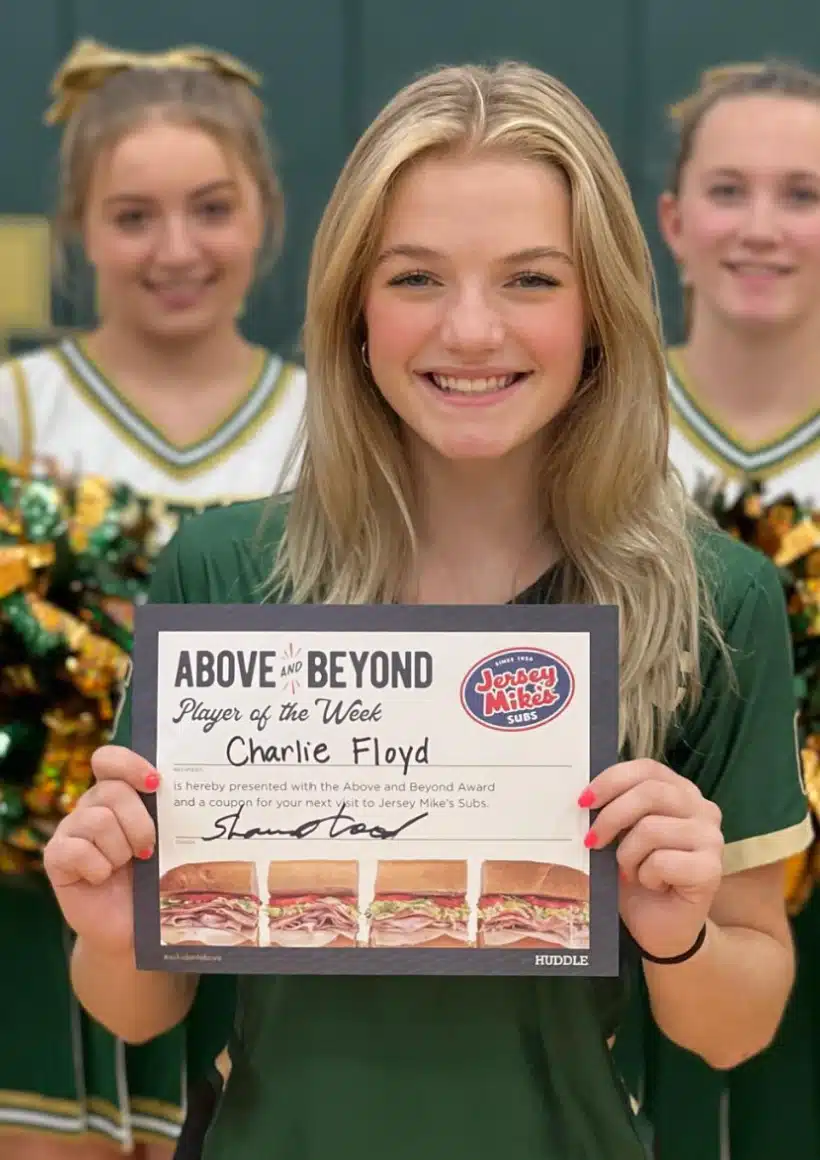 Student holding Jersey Mike's award