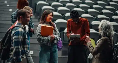 Students talking together in a campus auditorium