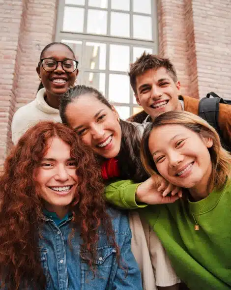 Group of student ambassadors smiling together on campus