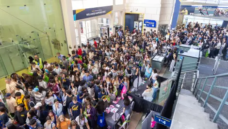 Large crowd of students gathered at a busy campus event entrance