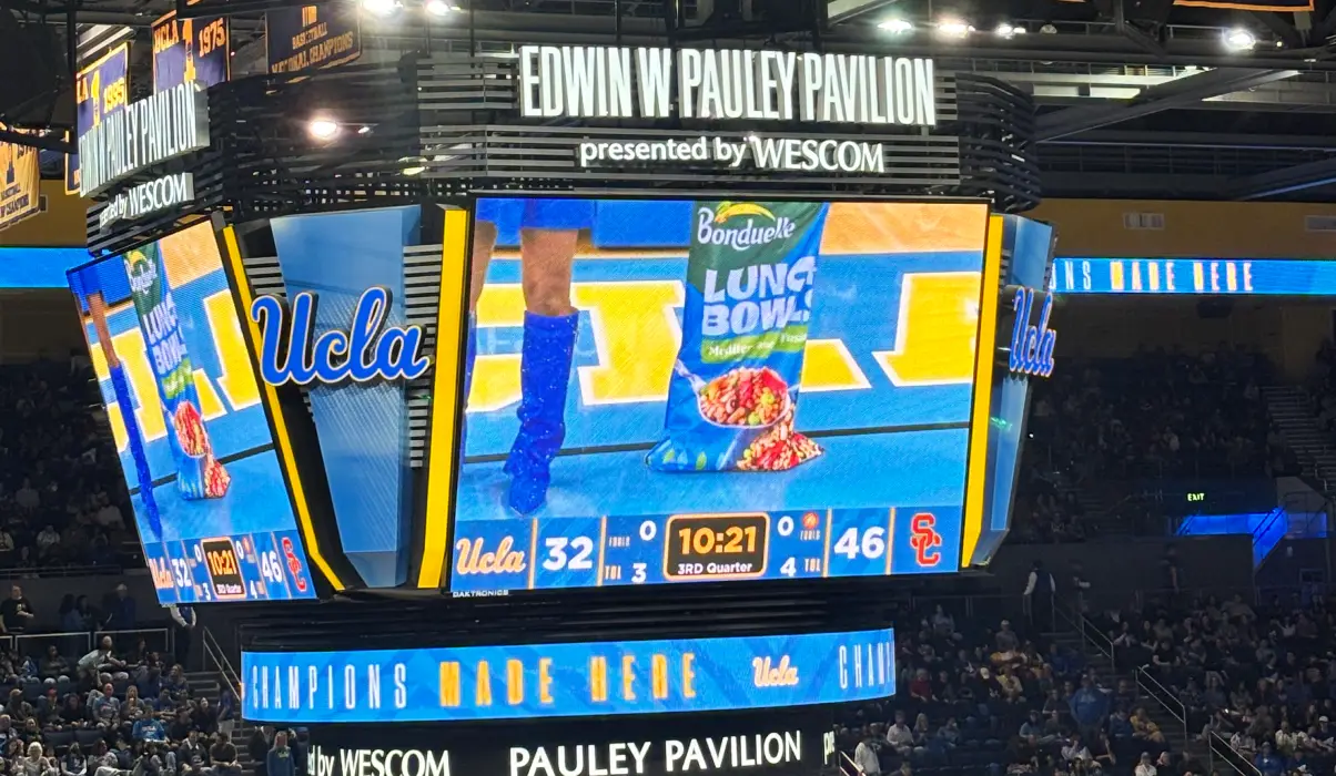 Arena scoreboard display at UCLA's Pauley Pavilion showing a Bonduelle Lunch Bowl advertisement during a basketball game