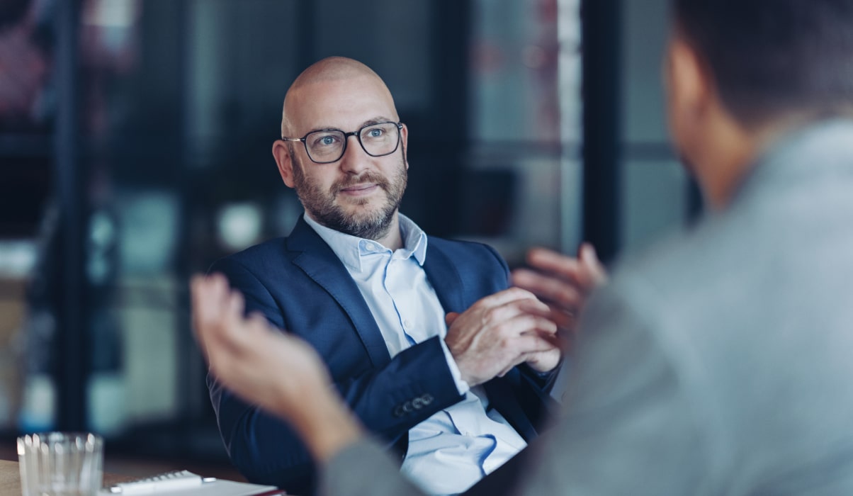Two business professionals discussing campus marketing strategy